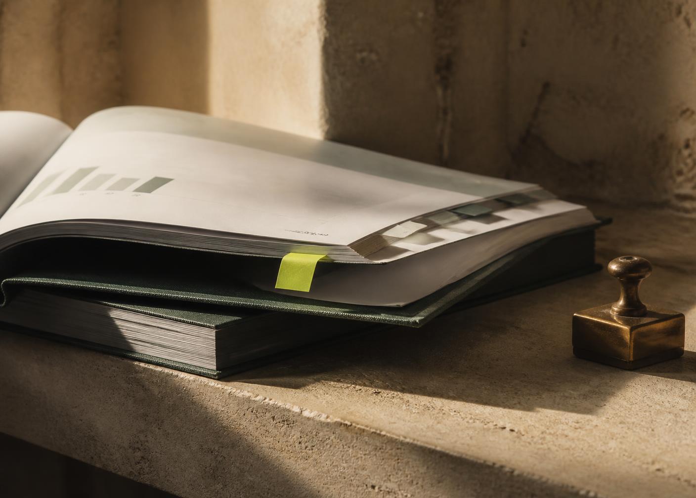 Bound compliance reports with a tabbed page and a date stamp